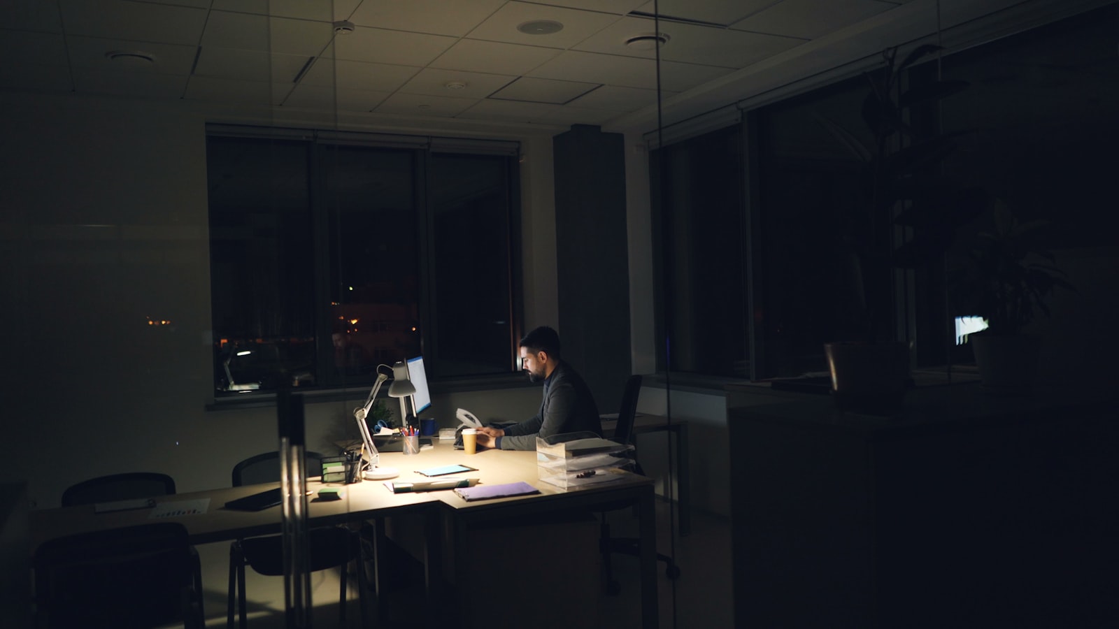 A founder working alone in a dark office late at night